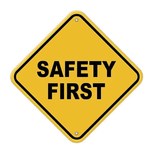 A yellow sign in which it is written safety first in black