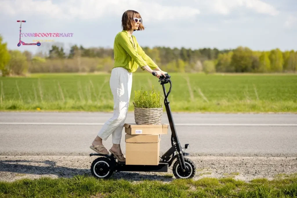 A woman wearing green shirt and white pants carrying things in boxes and plants on a best kick scooter for commuting on the side of the road