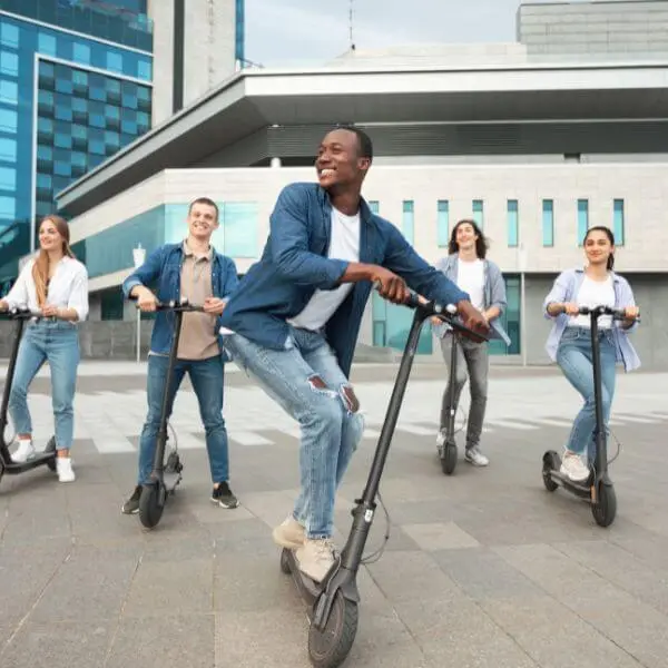 Five friends traveling with a kick scooter in group 