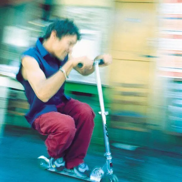 A man riding scooter in speed