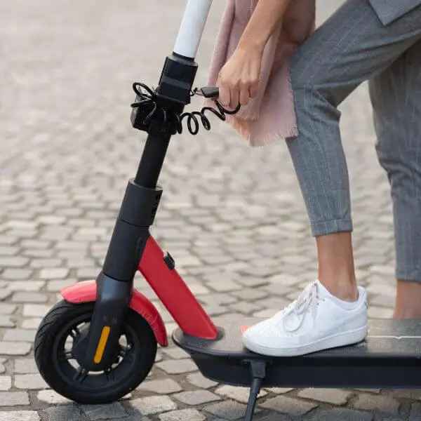 A woman showing How to lock a kick scooter